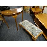 A reproduction mahogany demi-lune hall table together with a cushion topped long footstool