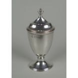 A SILVER PEPPERETTE of ovoid form raised over an oval base in the Georgian style, Chester 1920, 1.