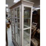 A good modern two-door glazed display cabinet with base drawer