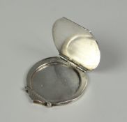 A CIRCULAR SILVER LOCKET with machine turned Art Deco style decoration (BBC Bargain Hunt)