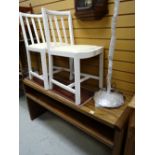 A modern two-tier side table & two white painted kitchen chairs