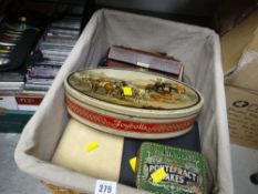 A wicker basket containing selection of vintage tins, jewellery boxes etc
