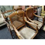 A pair of light oak rush seated spindle backed armchairs together with two other similar rush seated