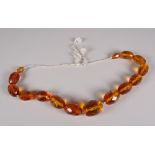 A STRAND OF FACETED & GRADUATED AMBER BEADS, fifteen beads total 14cms long (BBC Bargain Hunt)