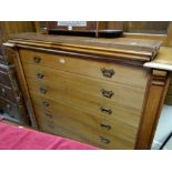 An early twentieth century mahogany library bookcase with a base of seven drawers