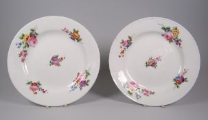 A PAIR OF NANTGARW PORCELAIN PLATES of plain non-moulded form & decorated with five sprays of