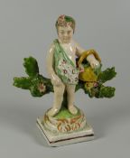 A RARE SWANSEA CAMBRIAN POTTERY PUTTO circa 1810-1815 flower picking while standing against a floral