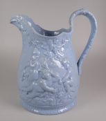 AN YNYSMEUDWY JUG (attributed to) in blue glazed with relief decoration of frolicking cherubs in a