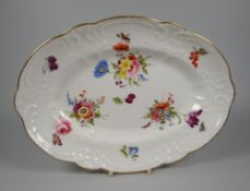 A NANTGARW PORCELAIN OVAL DISH moulded with sea-scrolls, flowers & wreaths, the interior painted