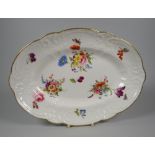 A NANTGARW PORCELAIN OVAL DISH moulded with sea-scrolls, flowers & wreaths, the interior painted