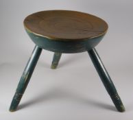 A PAINTED WELSH FARMHOUSE STOOL with turn decoration to the legs and seat, 33cms high