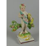 A RARE SWANSEA CAMBRIAN POTTERY PUTTO circa 1810-1815, flower picking while standing against a