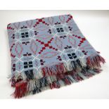 A WELSH WOOL BLANKET in bird's egg blue ground with black, burgundy and white geometric pattern