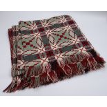 A WELSH WOOL BLANKET with green ground and black, burgundy and white geometric pattern and check