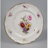 A NANTGARW PORCELAIN PLATE having a lobed border with moulded scrolls, foliage & ribbons