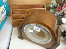 Polished mantel clock and a carved wooden letter rack