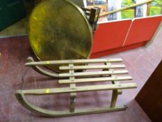Benares brass table and a child's wooden sledge