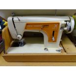 Cased Frister & Rossman portable sewing machine