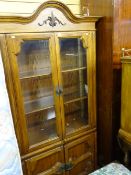 Medium coloured wooden bookcase cupboard with glazed doors and two lower panelled doors