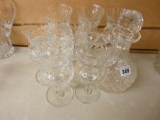 Seven thistle shaped high quality wine glasses and a circular based decanter with stopper