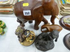 Two carved wooden elephants, bronze effect model of otters etc