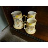 Graduated set of three Crown Devon blush decorated jugs