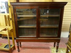 A GOOD VICTORIAN MAHOGANY SLIDING DOOR BOOKCASE on stand, 154.5 cms high, 144 cms wide, 38 cms