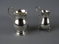 A SILVER THREE FOOTED CREAM JUG and a bulbous presentation tankard, London 1919, 2 troy ozs and