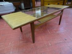 A G-PLAN TEAK GLASS TOPPED COFFEE TABLE, 42.5 cms high, 137 cms long, 51 cms wide