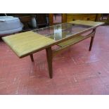 A G-PLAN TEAK GLASS TOPPED COFFEE TABLE, 42.5 cms high, 137 cms long, 51 cms wide