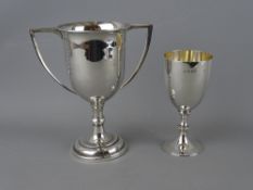 A SMALL SILVER GOBLET and a white metal twin handled trophy cup, London 1916, 2.8 troy ozs, the