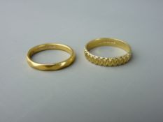 TWO PATTERNED GOLD WEDDING BANDS including an eighteen carat gold ring, size 'P' with arrow