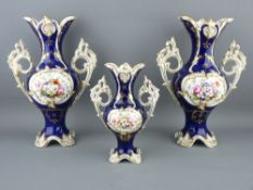 A GARNITURE SET OF THREE COALPORT STYLE TWIN HANDLED ROCOCO VASES, cobalt ground with hand painted