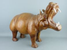A HIPPOPOTAMUS FORMED LEATHER FOOTSTOOL in the Liberty style, 38 cms high overall, 50 cms wide