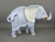 A HEREND PORCELAIN ELEPHANT retailed by Asprey, 25.5 cms high, 35 cms long