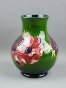 A MOORCROFT 'ANEMONE' LARGE BULBOUS VASE decorated on a green ground (crazing), 24 cms high