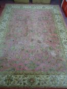AN INDO KESHAN ROSE & CREAM GROUND INDIAN WOOL PILE CARPET, 365 x 273 cms