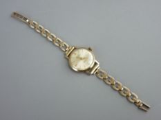 A LADY'S NINE CARAT GOLD CIRCULAR DIAL ROTARY WRISTWATCH and link bracelet strap, 12.5 grms gross