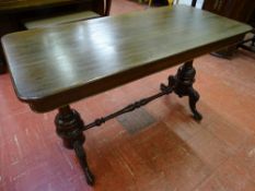 A VICTORIAN MAHOGANY SIDE TABLE on turned column and carved supports with connecting stretcher, 71.5