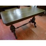 A VICTORIAN MAHOGANY SIDE TABLE on turned column and carved supports with connecting stretcher, 71.5