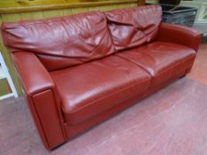 A STYLISH RED LEATHER EFFECT DOUBLE SOFA BED, 190 cms long, 90 cms deep