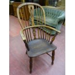 AN ANTIQUE WINDSOR FARMHOUSE ARMCHAIR with crinoline stretcher, 97 cms high, 56 cms wide, 38 cms