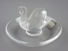 A LALIQUE SWAN PIN DISH with original paper label and engraved signature to the base, 6 cms high,