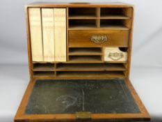 A DOVETAILED OAK TRAVELLING WRITING DESK with brass mounts and carry handle, drop down front slope