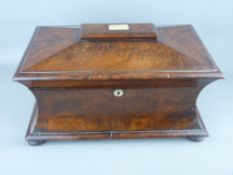 A VICTORIAN MAHOGANY WAISTED FORM SARCOPHAGUS TEA CADDY having twin interior lidded containers and