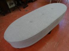 A MODERN BUTTON UPHOLSTERED OVAL SEAT, 48 cms high, 173 cms wide, 63 cms deep