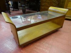 A G-PLAN GLASS TOPPED COFFEE TABLE with curved ends, 51 cms high overall, 121.5 cms wide, 51.5 cms