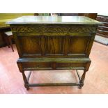 A VINTAGE OAK LIDDED CHEST ON STAND with twin frieze drawers on turned supports, 96 cms high, 84.5