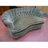 A VINTAGE BUTTON UPHOLSTERED CURVED BACK COUCH with serpentine front on bun feet, 75 cms high, 153