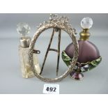 Butterfly decorated scent bottle and one other with a hallmarked silver portrait frame